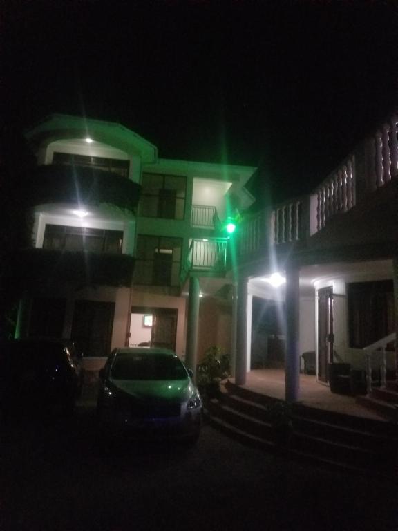 a car parked in front of a building at night at Spannet Suites in Mbarara