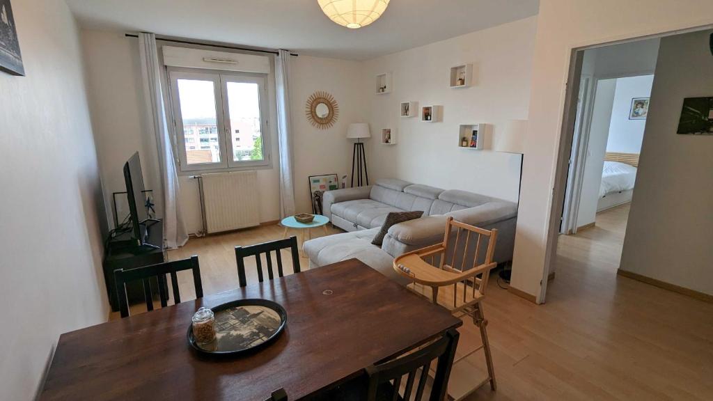 een woonkamer met een tafel en een bank bij Paris'door Cozy 2P 50m² all equipped in a village in Pré Saint Gervais