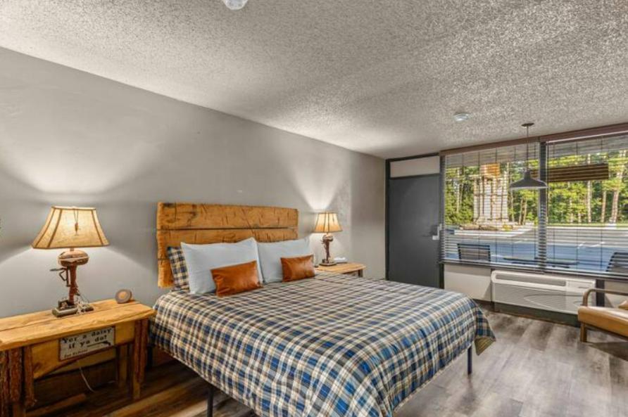 a bedroom with a bed and a desk and a window at Stonegate Lodge W Pool & Outdoor Firepits Room #201 in Eureka Springs