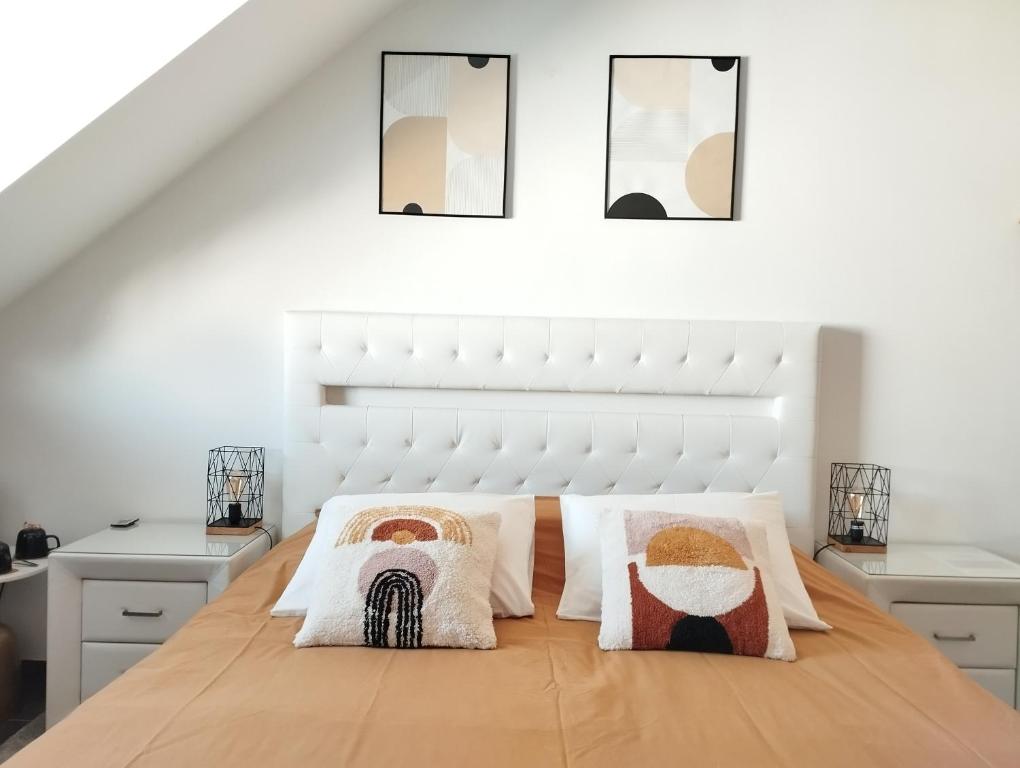 a white bedroom with a large bed with two pillows at Sweetnest by home in Waterloo