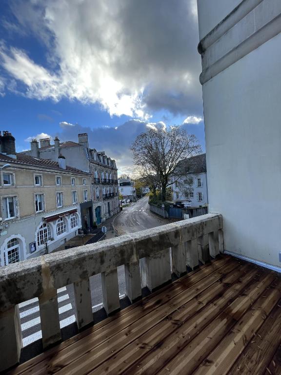 a balcony with a wooden deck and a street at L&#39;aristide in Épinal