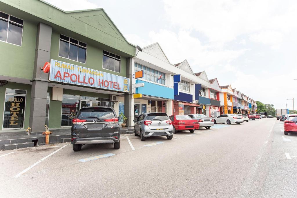 a row of cars parked in a parking lot next to buildings at Apollo Hotel Johor Bharu in Johor Bahru