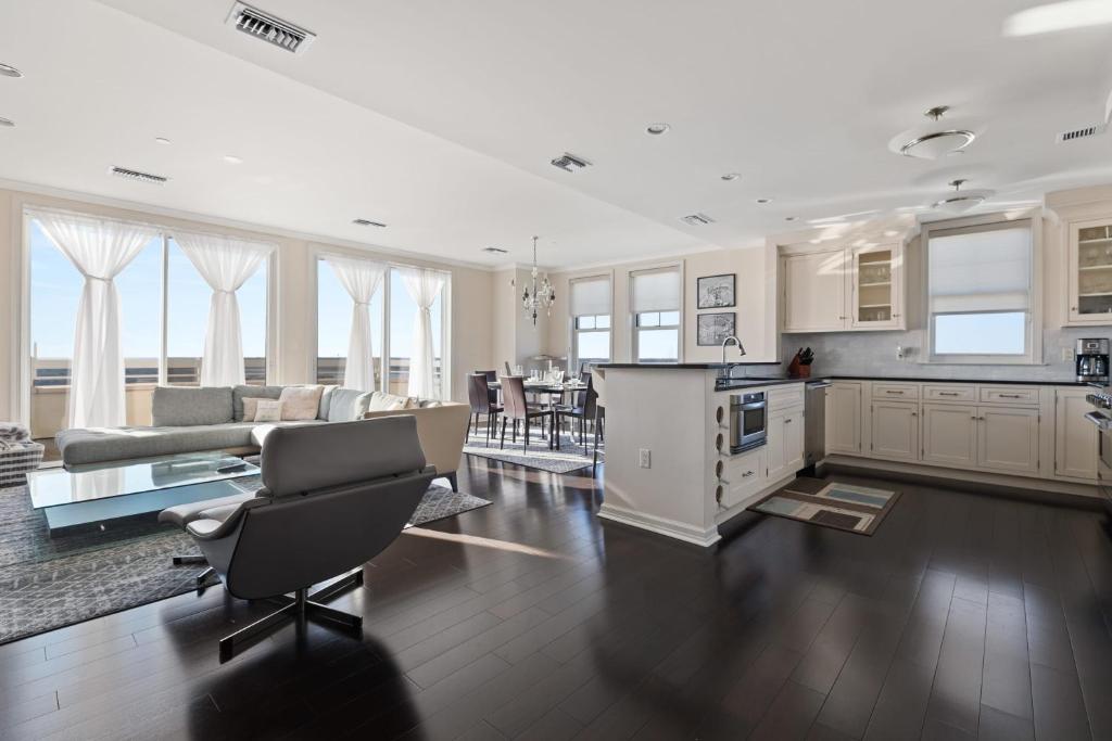 a large kitchen and living room with a table and chairs at Luxury Living at The Grand in Wildwood
