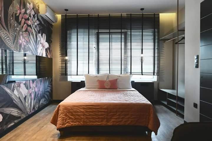 a bedroom with a large bed and a large window at Avenue Luxury Apartments in Alexandroupoli