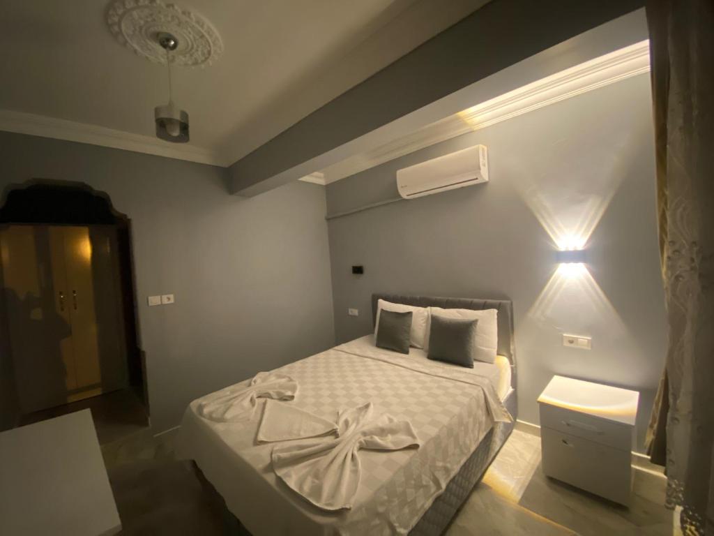 A bed or beds in a room at Aspawa Hotel