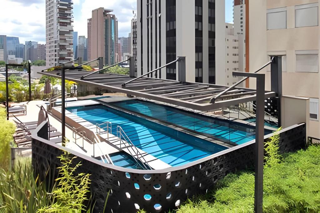 a swimming pool on the roof of a building at Nun Apartments by BnbHost in Sao Paulo