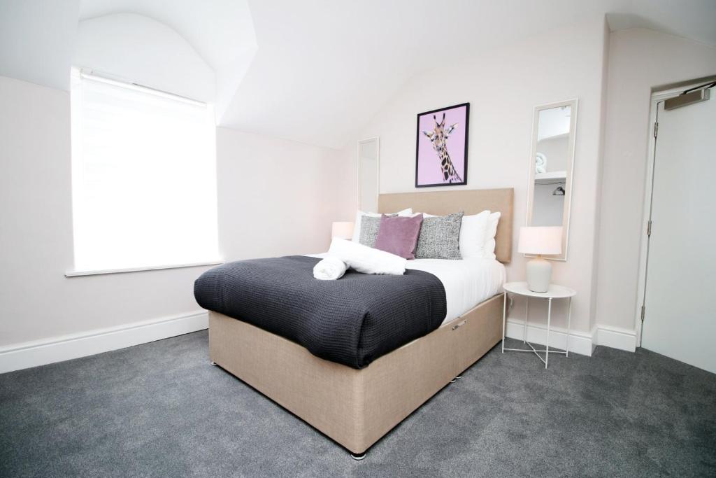 um quarto com uma cama grande e uma janela em Stay with Free Parking at Archer Road Penarth em Cardiff