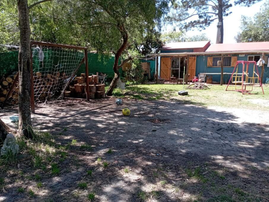 a yard with a house and a playground at La Floresta in La Floresta