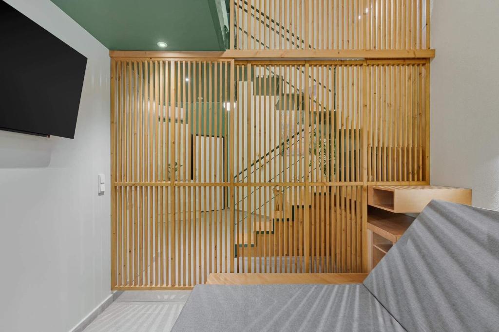 a room with a wooden partition with a staircase at Mystique Loft Ioannina in Ioannina