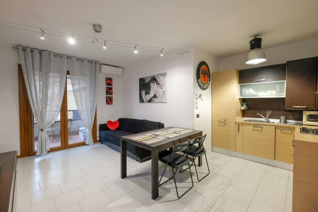 a kitchen and living room with a table and a couch at Intero alloggio: appartamento in Bergamo