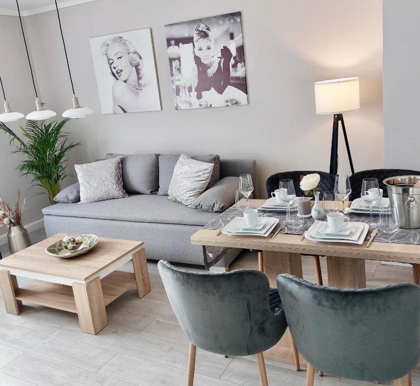 a living room with a table and a couch at Apartment am Hochwald in Reinhardtsdorf