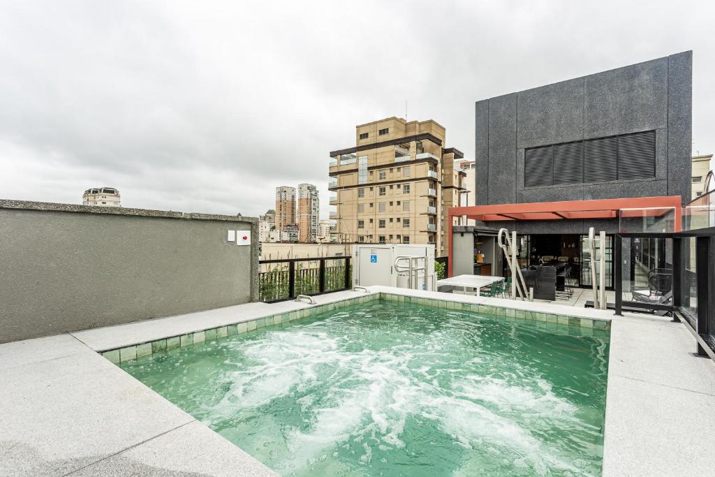 a swimming pool on the roof of a building at Charlie Sabiá Moema in Sao Paulo