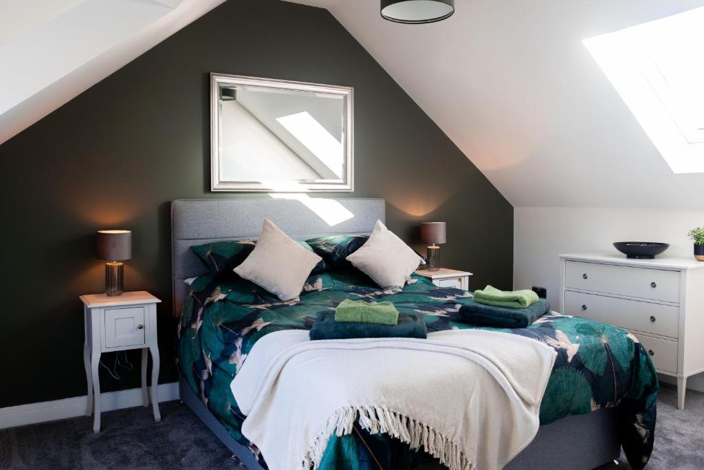 a bedroom with a bed with pillows on it at Emerald Lodge in Puddletown