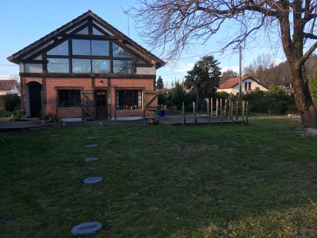 une maison avec une cour avec des frisbees dans l'herbe dans l'établissement Chez Loulou, à Léon