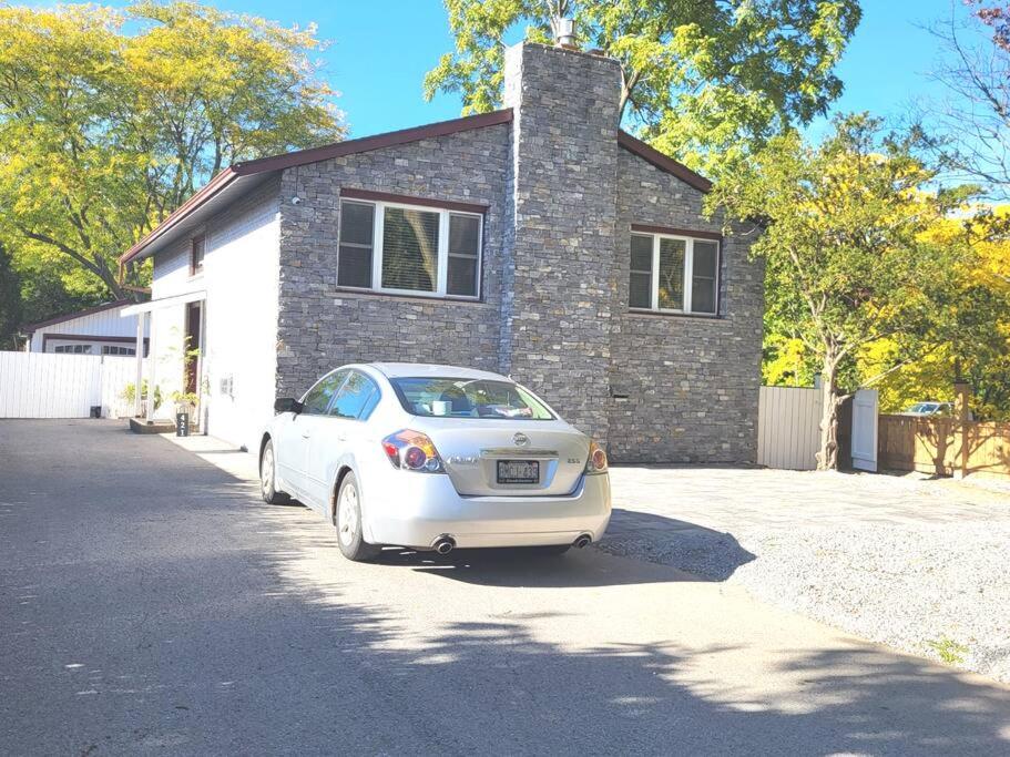 a white car parked in front of a house at Cozy Home in Niagara-on-the-Lake in Niagara on the Lake