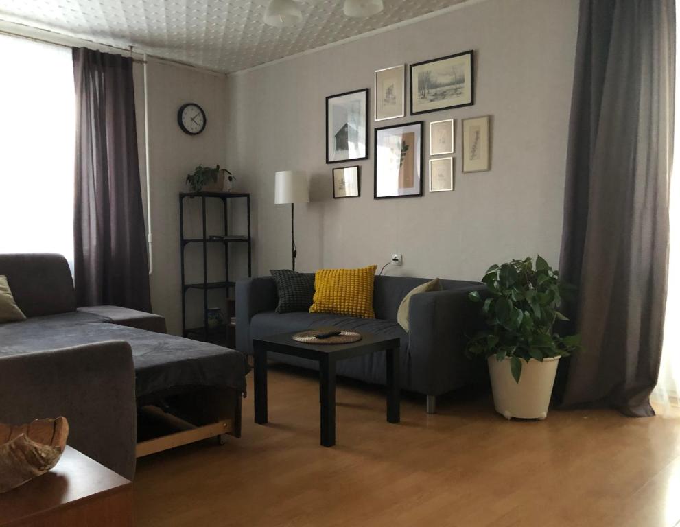 a living room with a couch and a table at Skolas 1 in Salaspils
