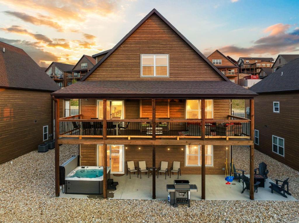 a large house with a deck and a swimming pool at Near Indoor & Outdoor Pools: Hot Tub, Game Room & Free SDC Tickets in Kimberling City