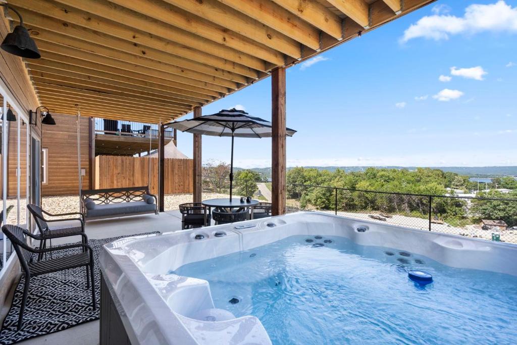 a hot tub on the patio of a house at Laketopia Lodge in Kimberling City