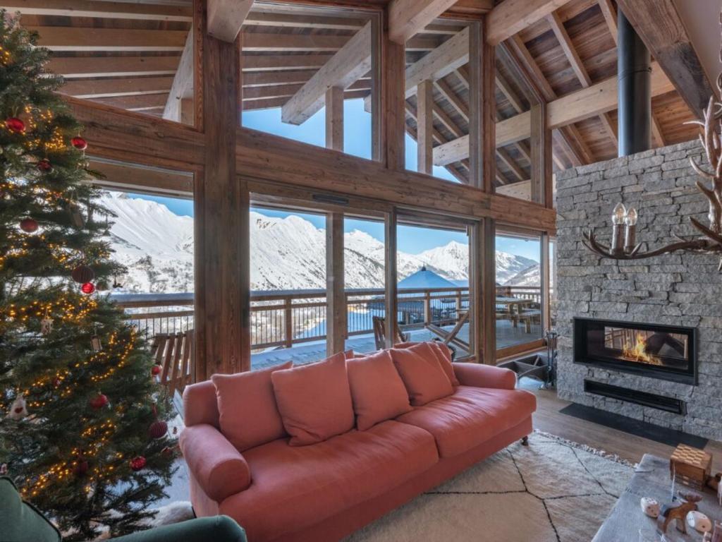 a living room with a couch and a christmas tree at Chalet Saint-Martin-de-Belleville, 6 pièces, 12 personnes - FR-1-570-50 in Saint-Martin-de-Belleville