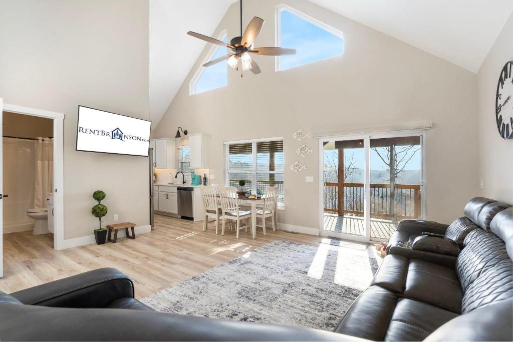 a living room with a couch and a ceiling fan at Timber's Edge in Kimberling City