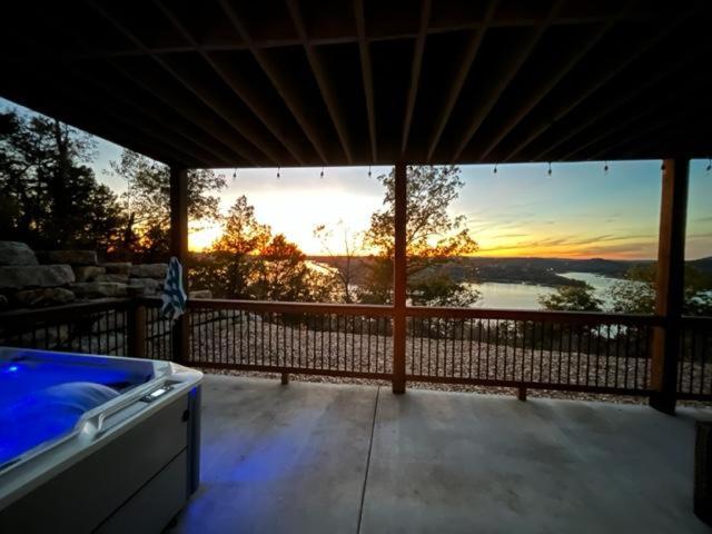 a screened in porch with a view of the water at Sunset Bluff at Table Rock Lake in Kimberling City