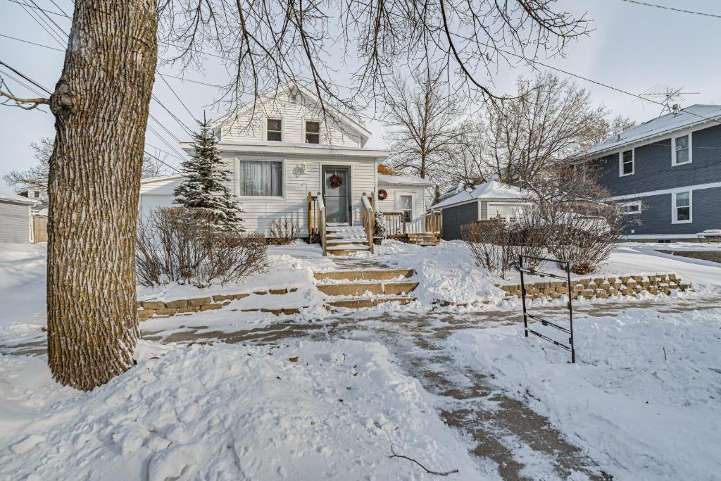 a white house with snow on the ground at Charming Crookston Home Walk to Downtown! in Crookston