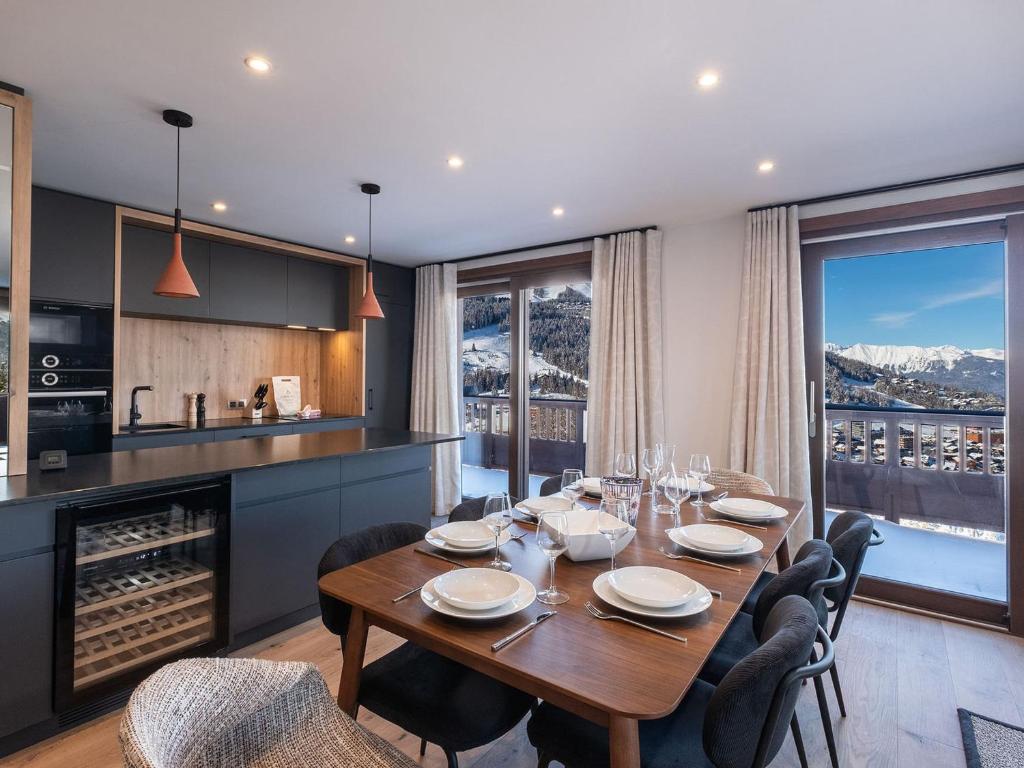 a dining room with a table and some chairs at Appartement Courchevel 1650, 5 pièces, 8 personnes - FR-1-563-136 in Courchevel