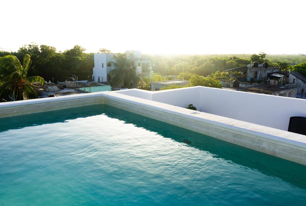 a swimming pool on the roof of a house at Itza Hotel Akumal - Dive House in Akumal