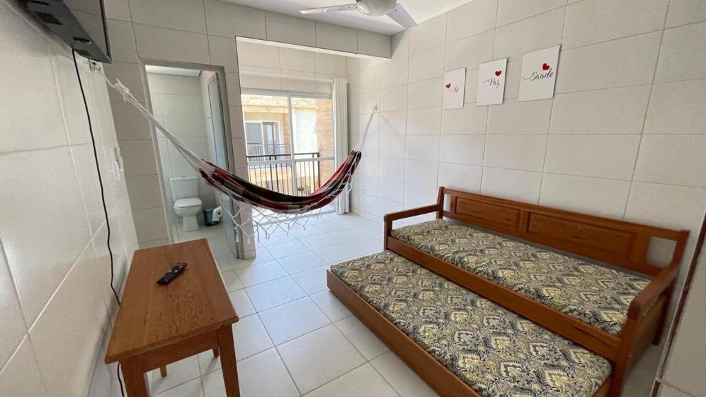 a room with two beds and a hammock in it at Recanto Vó Mônica in Palhoça