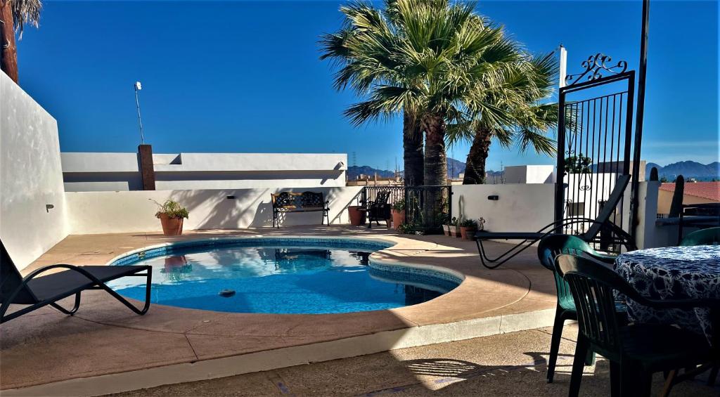 聖卡洛斯的住宿－Casa Loma Bella 1 con Alberca Privada Vista Increible，庭院内的游泳池,配有桌椅