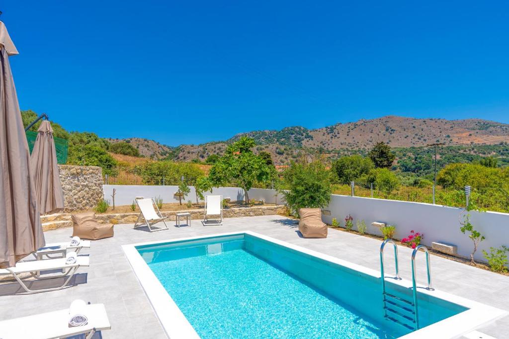 a villa with a swimming pool with a view at Villa Koupos in Karé