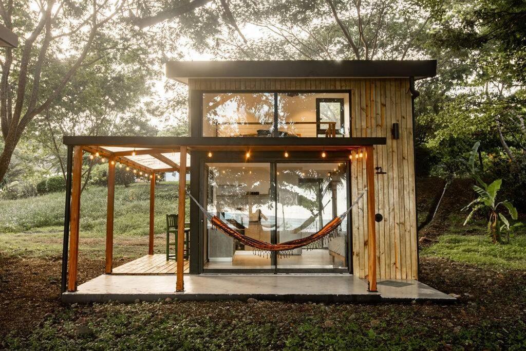 a tiny house with a hammock inside of it at Mind- Tiny Home Venao Cove in Playa Venao