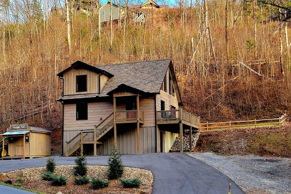 a house on a hill with a driveway at Lil Cabin in the Cove in Sevierville