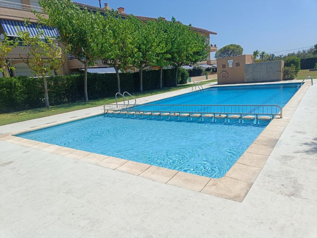 a large swimming pool with blue water at Cozy apartment with pool close to beach & nature in L'Estartit