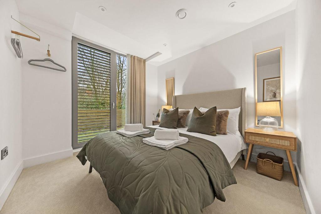 a bedroom with a large bed and a window at Atlas House Five in Harrogate