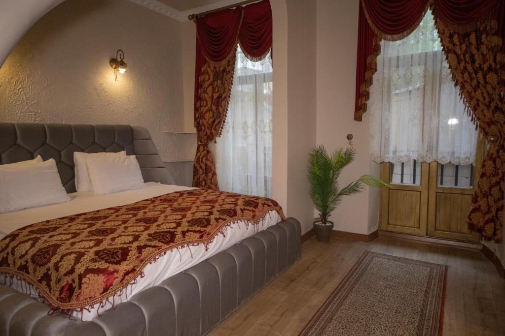 een slaapkamer met een groot bed met een lederen hoofdeinde bij BeyPort Hotel Taksim in Istanbul