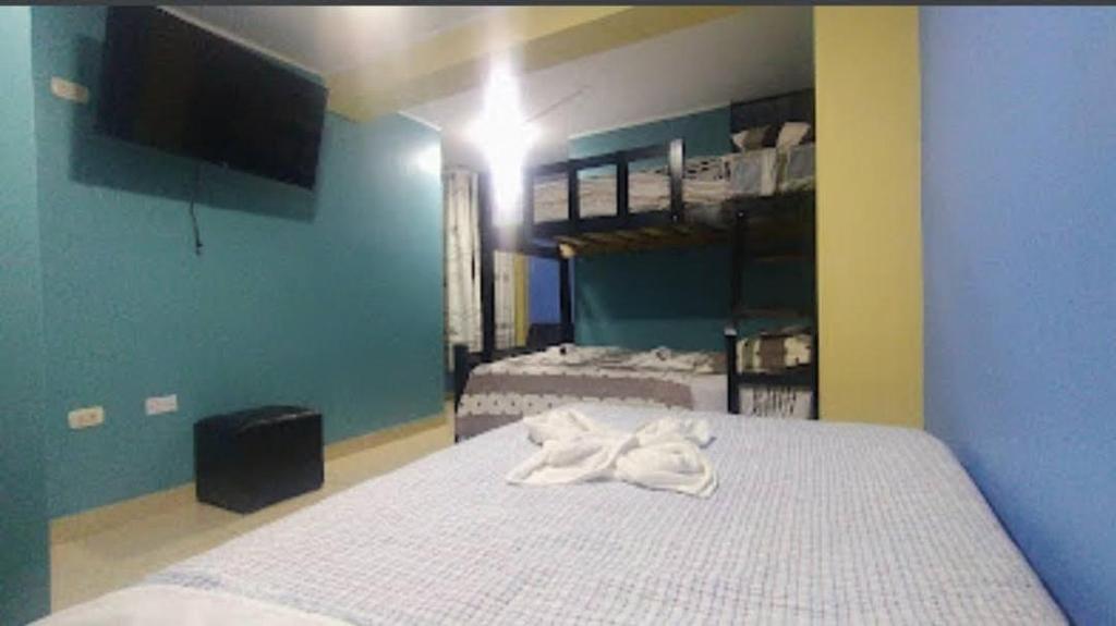 Postel nebo postele na pokoji v ubytování Hostal Milagros