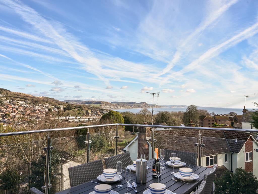 a view from the balcony of a house with a table at Apartment 5 Victoria House in Lyme Regis