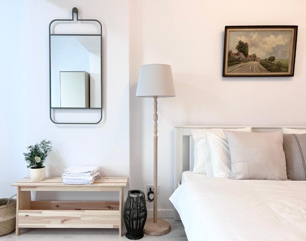 a bedroom with a bed and a mirror on the wall at Apartament Vivo & Pool access - Free parking in Constanţa