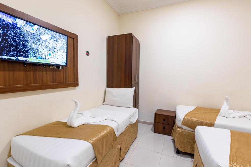 Cama ou camas em um quarto em فندق المسار أجياد - ALMASAR AJIAD HOTEL