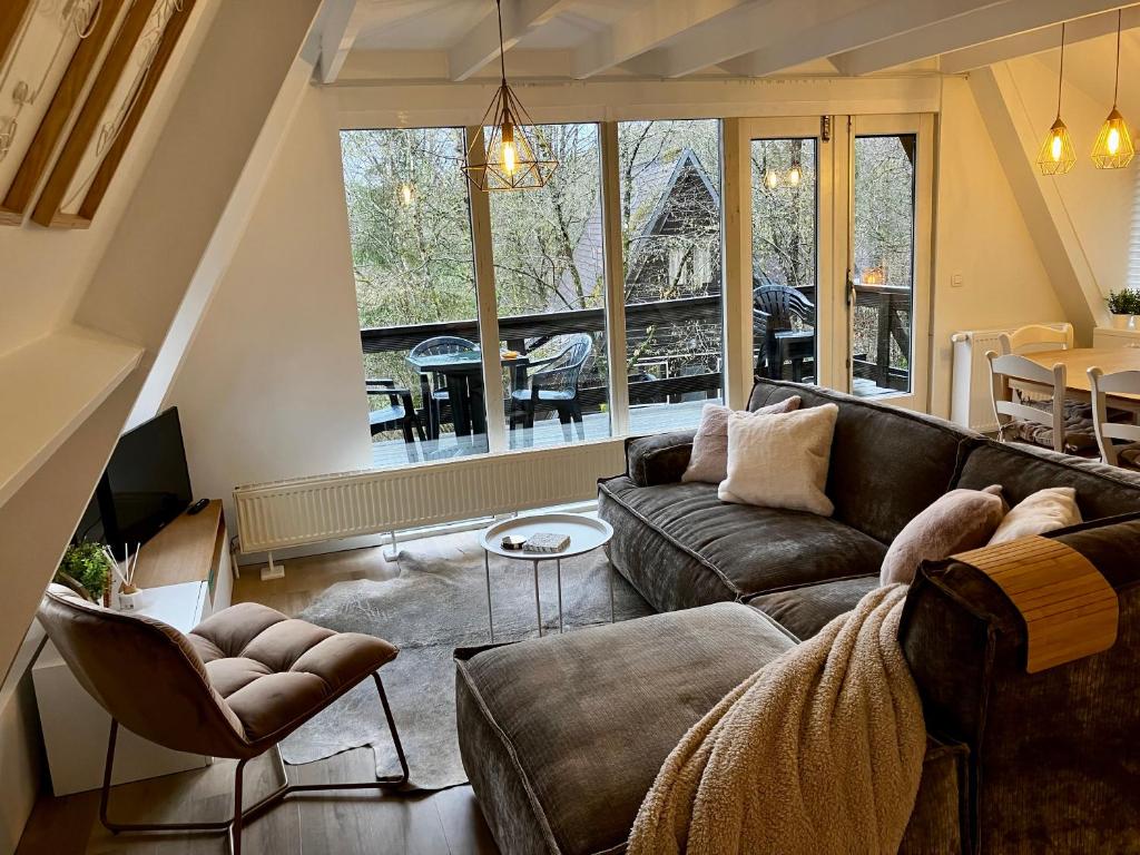 a living room with a couch and a table at Chalet 190 La Belle Durbuy in Durbuy