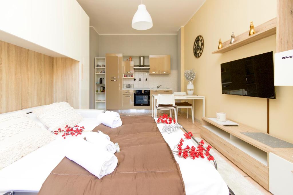 ein Schlafzimmer mit einem großen Bett mit roten Blumen darauf in der Unterkunft STAR Suite, Malpensa - Rho Fiera Milano 15 min in Legnano