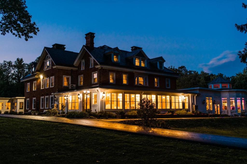 a large house lit up at night at Cameron Estate Inn in Mount Joy