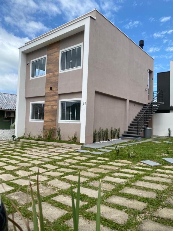 a large building with a grass yard in front of it at Residencial Mariano 5 in Florianópolis