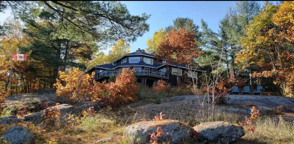 a large house on a hill in the forest at The Boshrock in Carnarvon