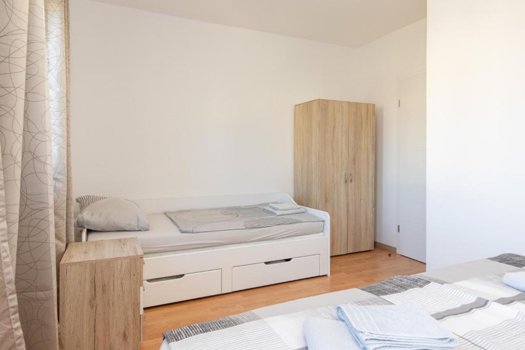 Posteľ alebo postele v izbe v ubytovaní Tom's House Njivice