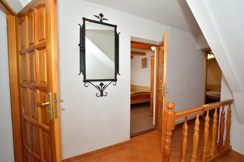 a hallway with a mirror and a staircase at Willa Świerk - Panorama Tatr in Zakopane