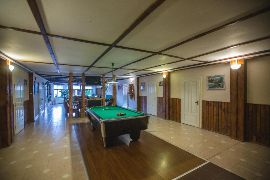 a large room with a pool table in it at Guest House Podobovets 2000 in Podobovets