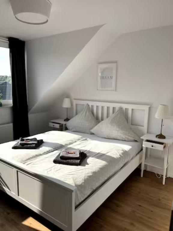 a bedroom with a white bed with two trays on it at Wohnung am CentrO! in Oberhausen