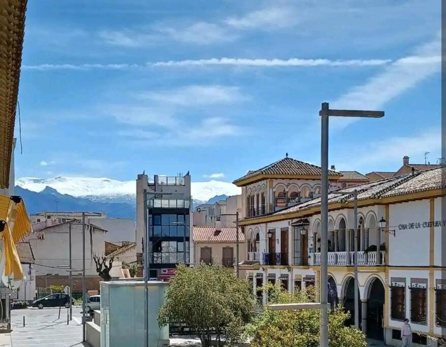 a city street with buildings and a street light at Acogedor piso a un paso de Granada Capital. in Granada